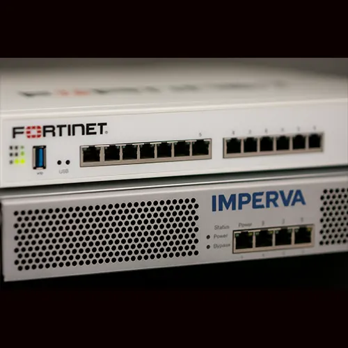 Fortinet vs Imperva devices side by side on a dark background, showing physical design and branding for visual comparison.
